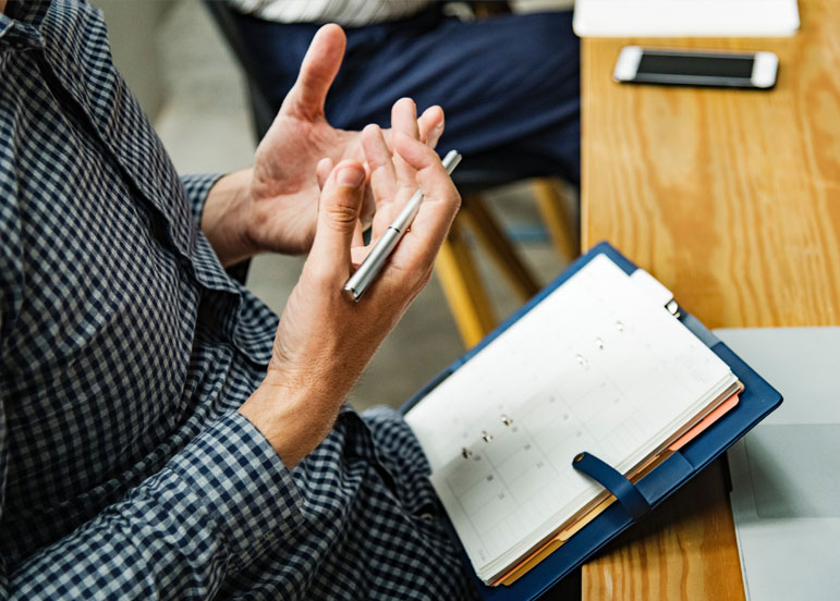 A person holding a diary at work